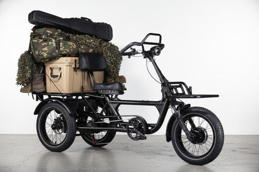 The rear cargo rack of the LLAMA HT10 fully loaded with camo hunting gear, a heavy cooler, and a rifle case, showing off its heavy-duty payload capacity.